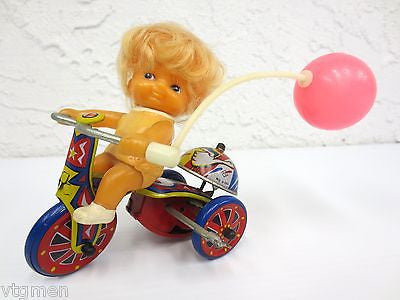 Vintage Mid Century Wind-Up Toy, Blond Girl Riding a Tricycle with Pink Balloon